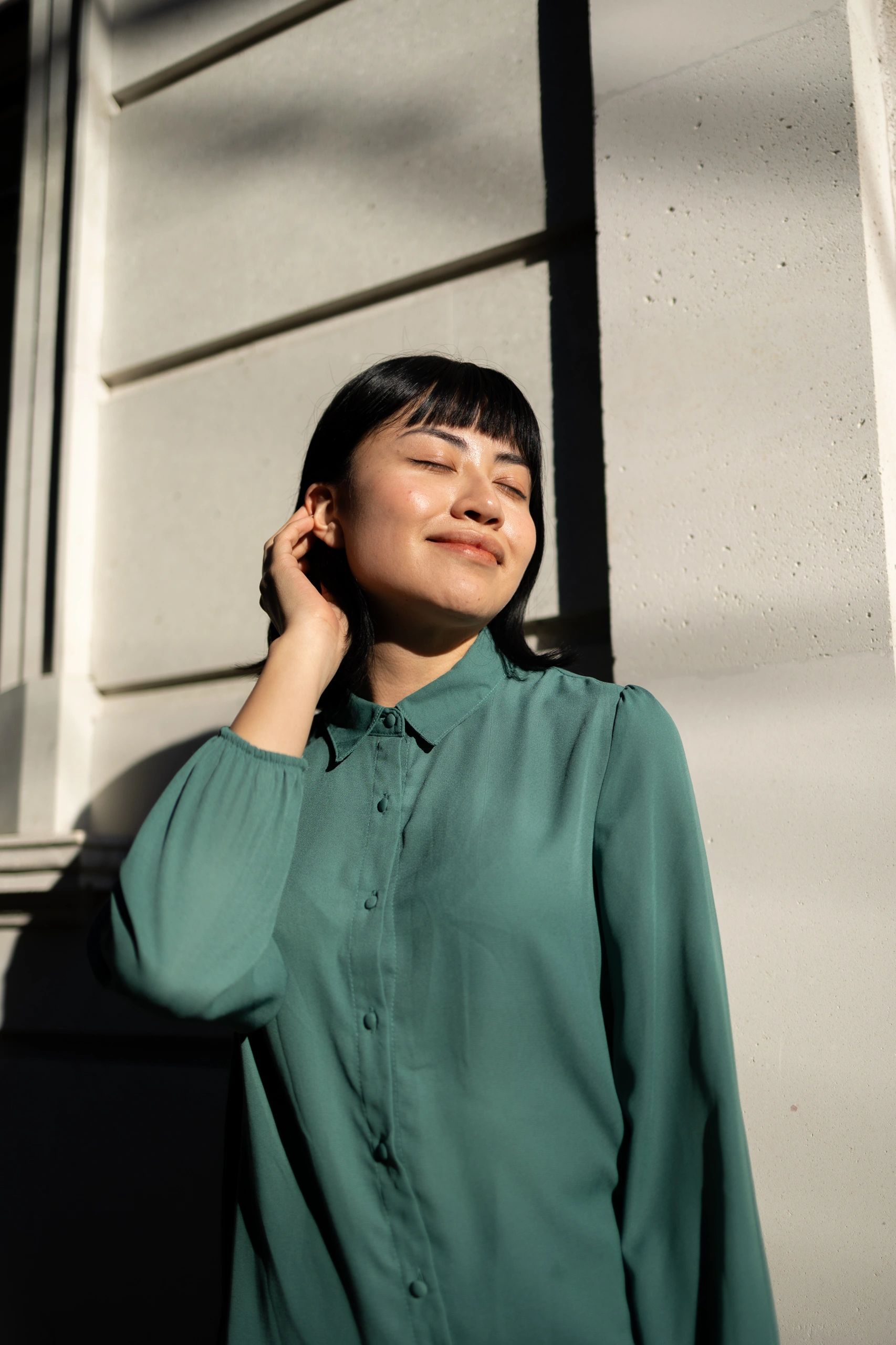 Low angle portrait of a young woman in sunlight