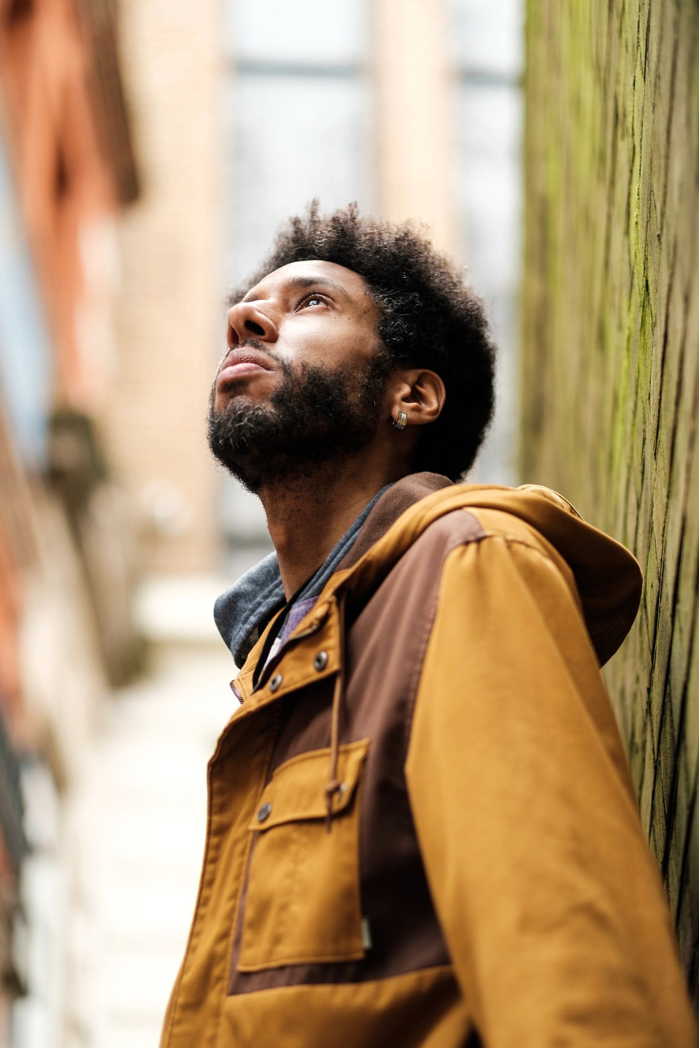 Portrait of a young man in a narrow urban street