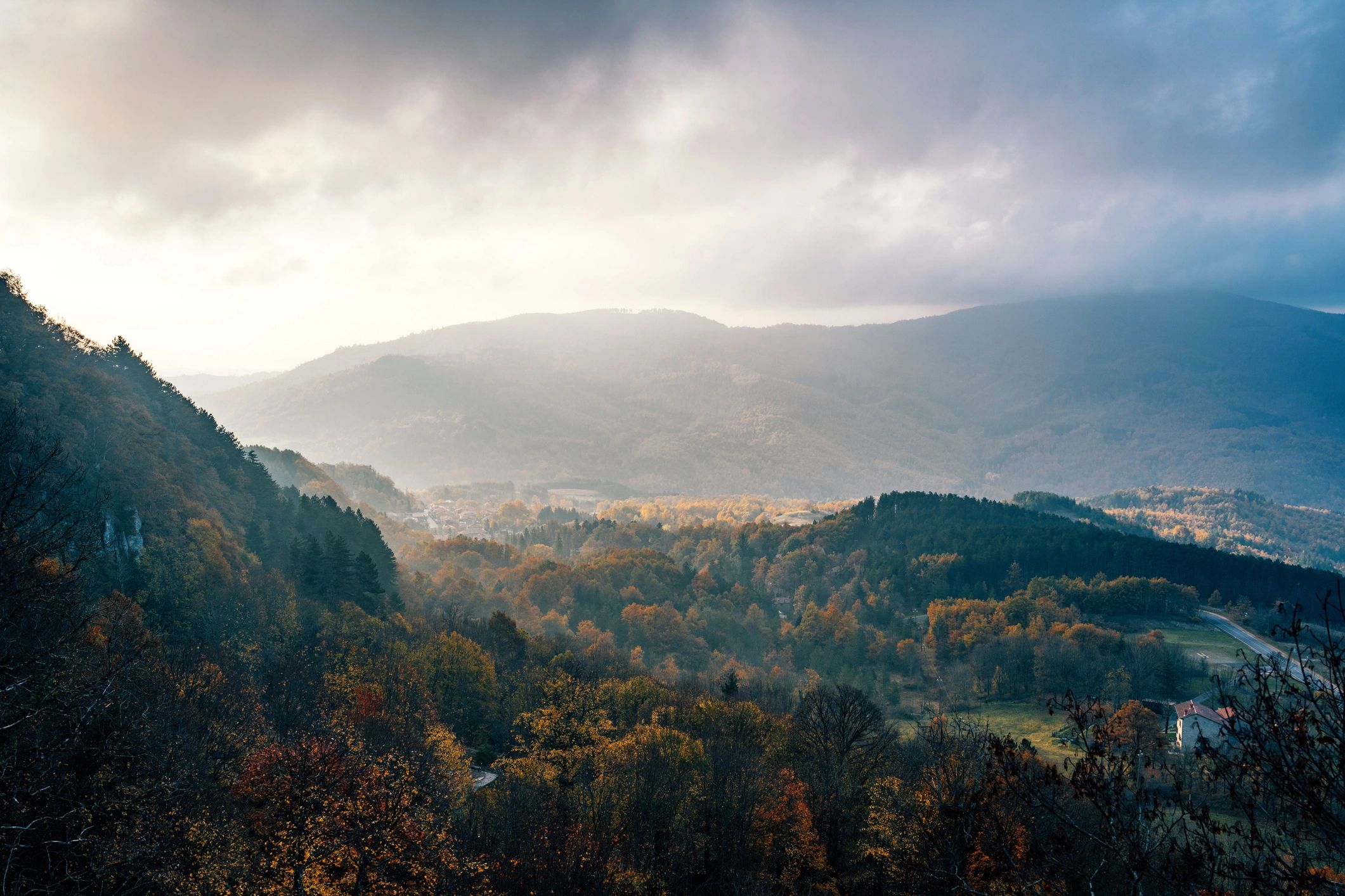 Autumn mountain valley at sunrise with mist